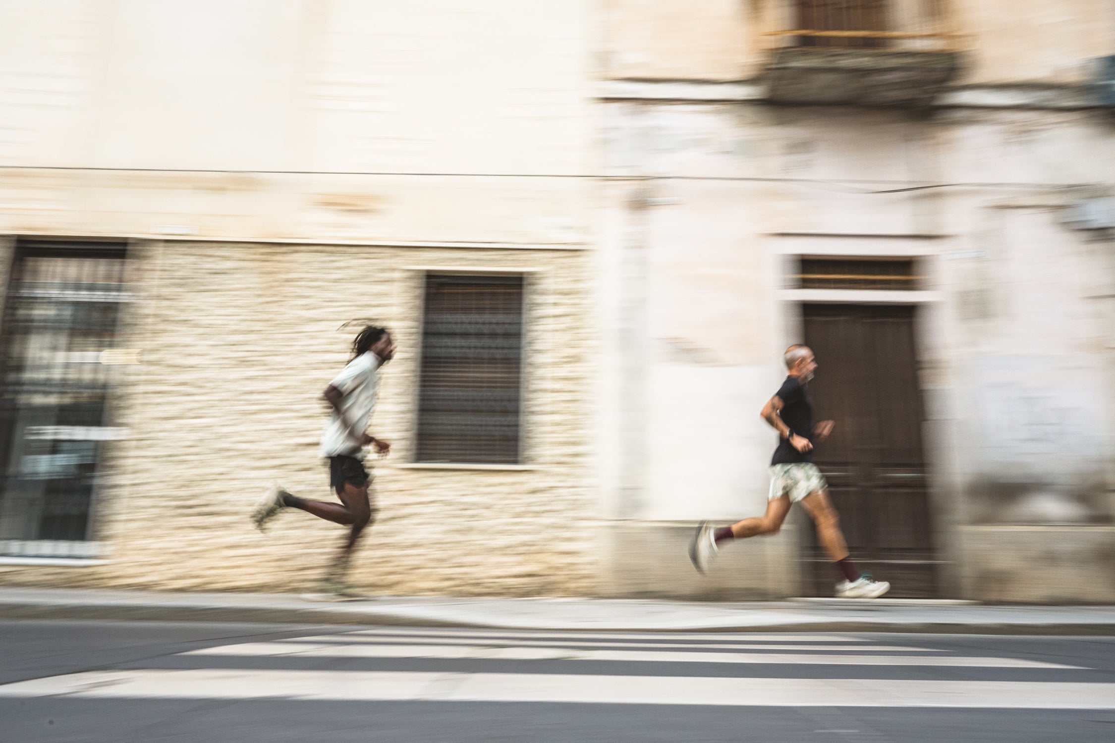 two men running down the streets of Sardinia in Roark Run Amok clothing