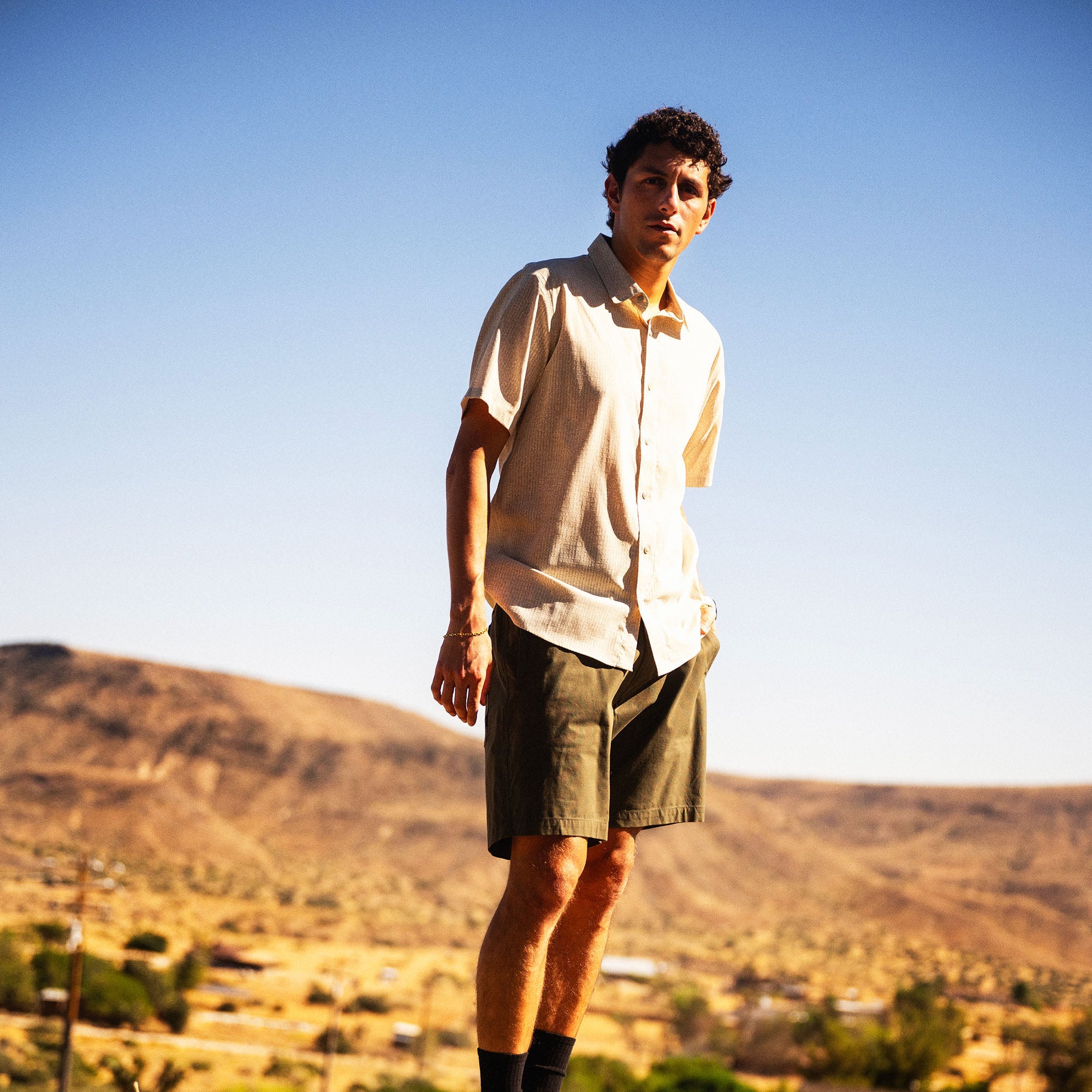 Bless Up Breathable Stretch Shirt in Sand, worn by a model outdoors in a desert landscape