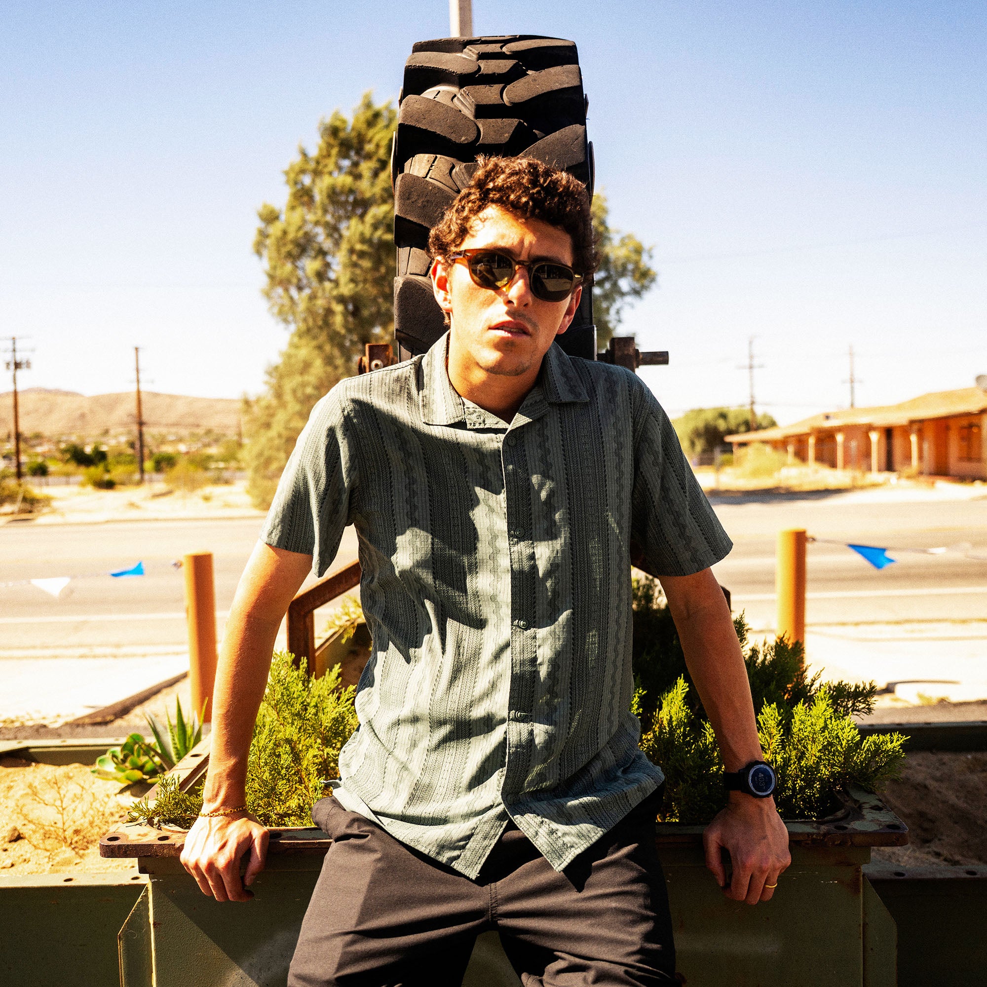 Bless Up Trail Button Up Shirt, worn by a model seated in a desert landscape