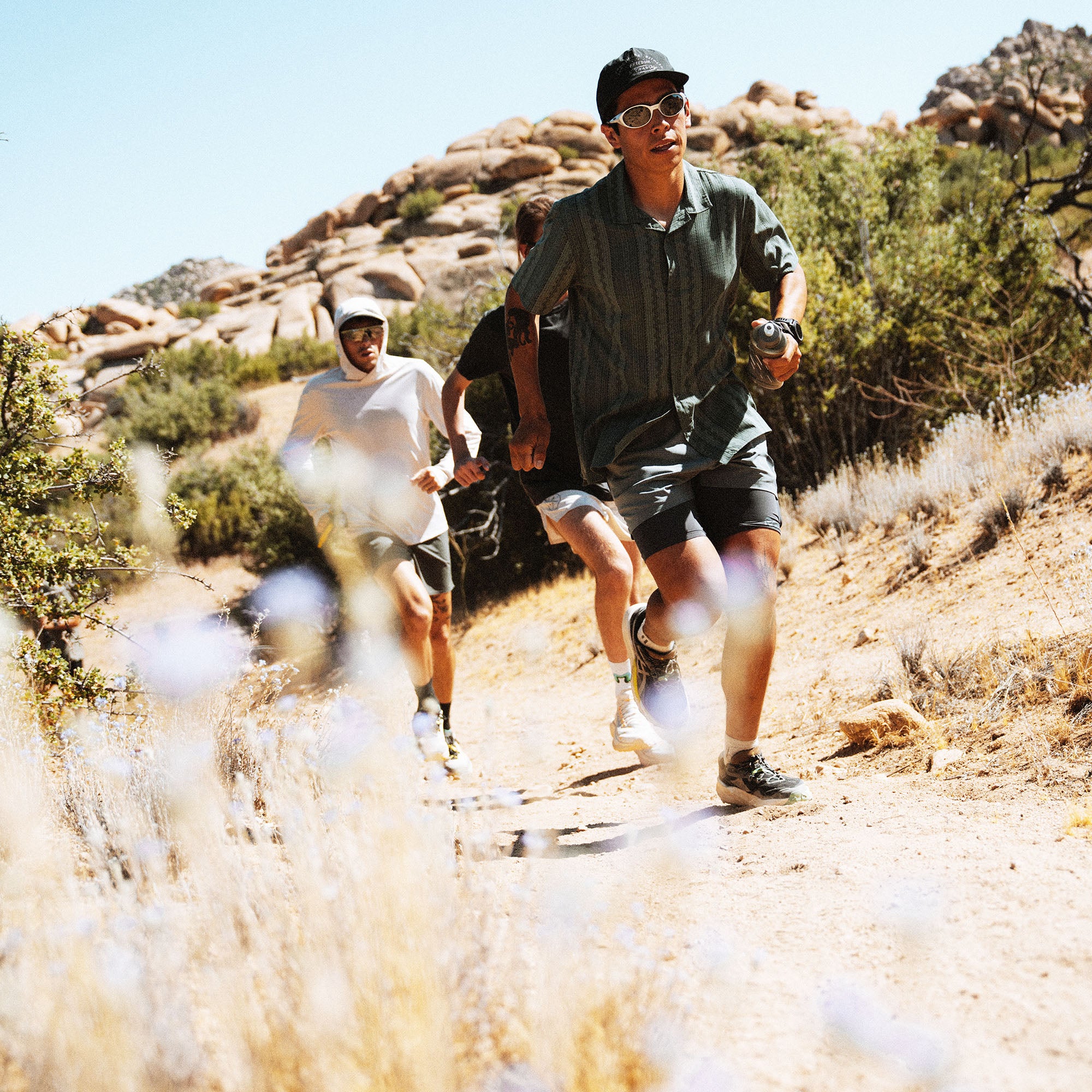 Bless Up Trail Button Up Shirt, worn by three runners on a desert path