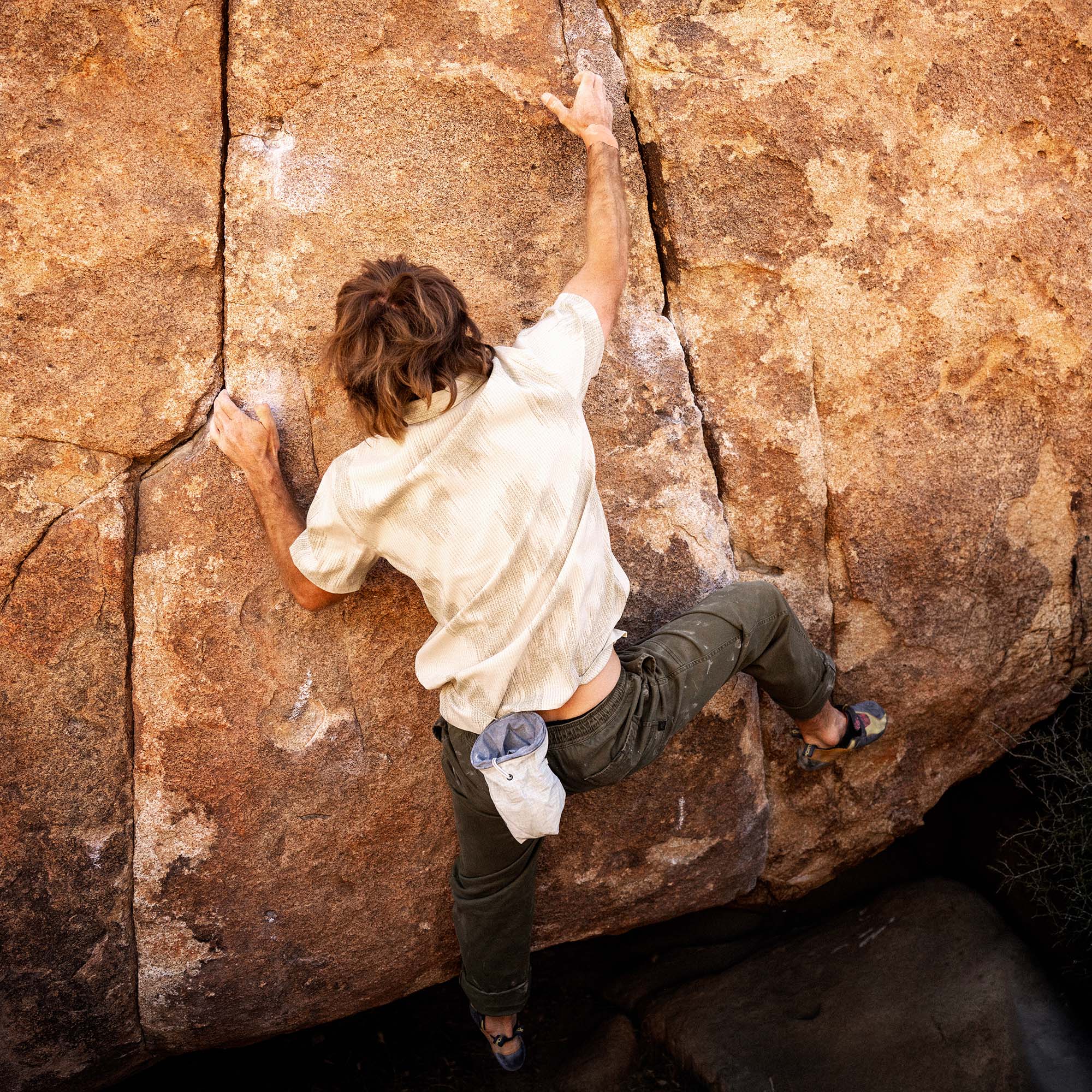 Bless Up Trail Button Up Shirt in Sand, worn by a boulderer, overhead view