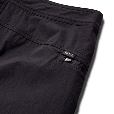 Close-up view of a textured black fabric from Roark's adventure gear collection, emphasizing durability and style for outdoor activities.